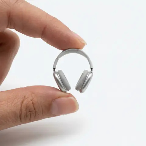 Miniature Product Between Fingers Studio Shot